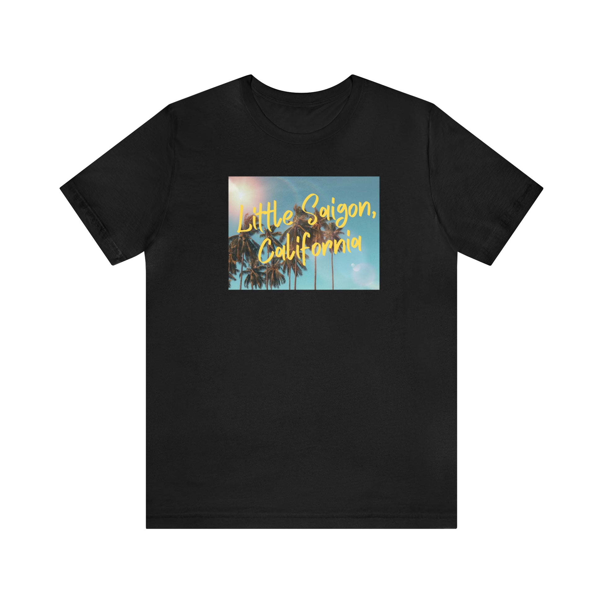 Black t-shirt with square picture of a shining sun, palm trees, and blue sky with words Little Saigon, California written in yellow letters across the picture. Front view