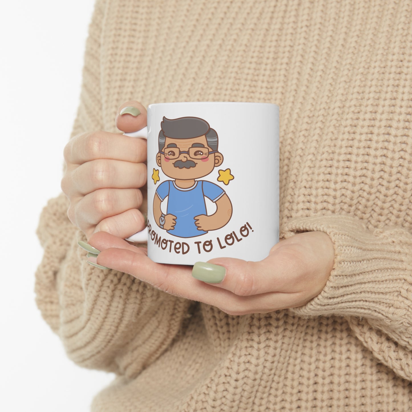 White mug with a kawaii picture of an old man with a mustache wearing glasses. A caption below the picture reads Promoted to Lolo! Front view