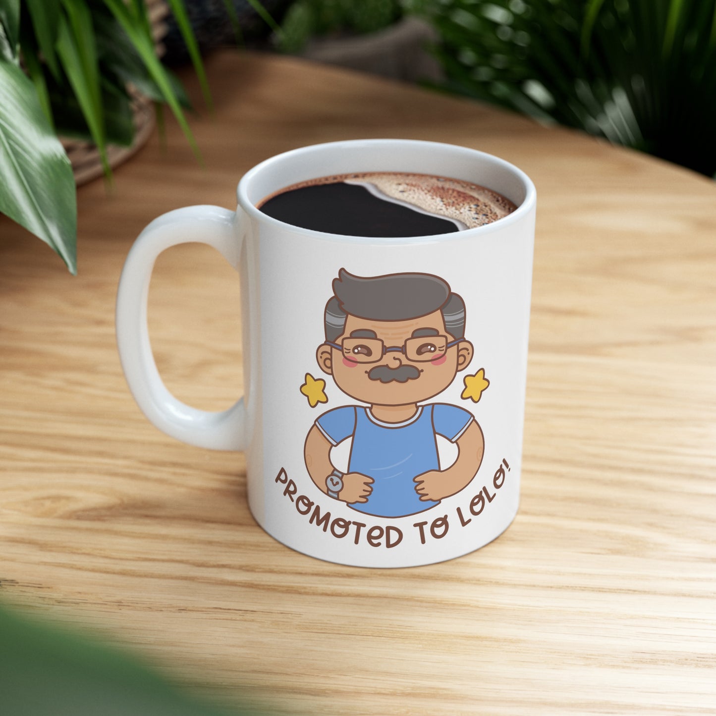 White mug with a kawaii picture of an old man with a mustache wearing glasses. A caption below the picture reads Promoted to Lolo! Front view