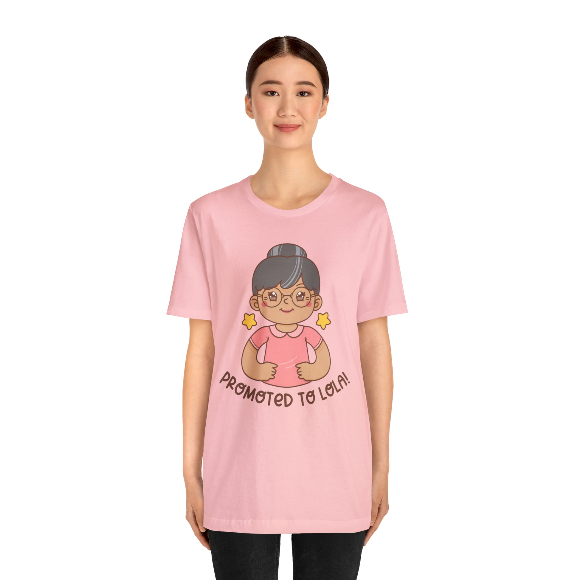 Pink t-shirt with kawaii grandmother wearing glasses and her hair in a bun with the words Promoted to Lola! under the picture.