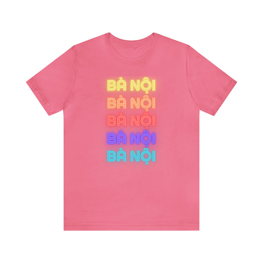 Five rows of the words Ba Noi with each row a different color of the rainbow. Pink shirt. Front view.