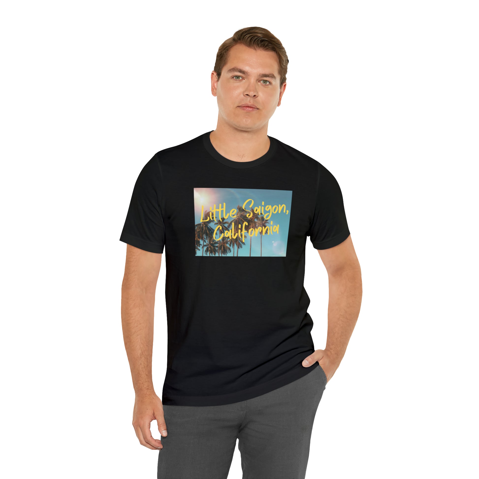 Black t-shirt with square picture of a shining sun, palm trees, and blue sky with words Little Saigon, California written in yellow letters across the picture. Front view